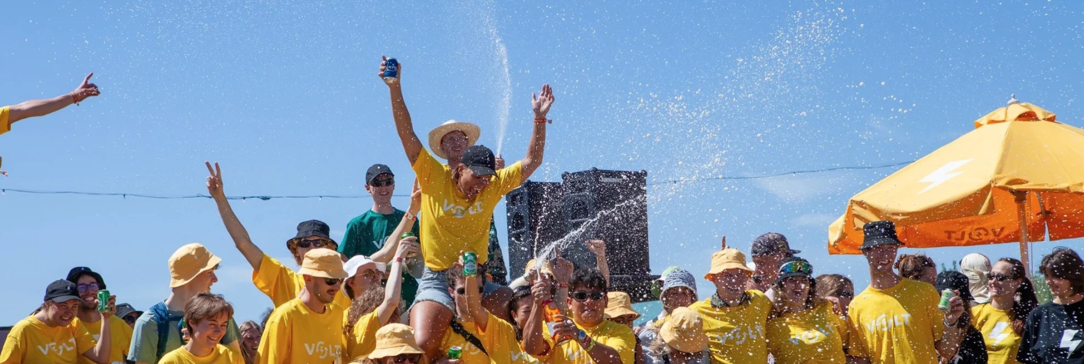 Volt volunteers in yellow shirts celebrating at the festival