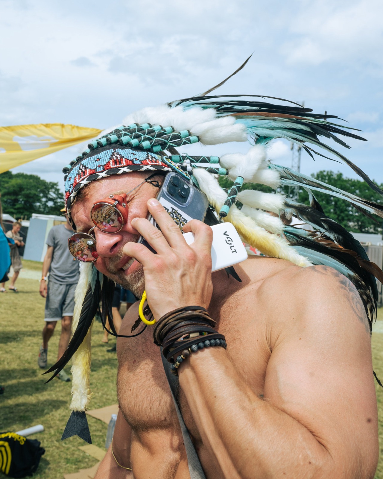 Festival guest on the phone with a Volt power bank